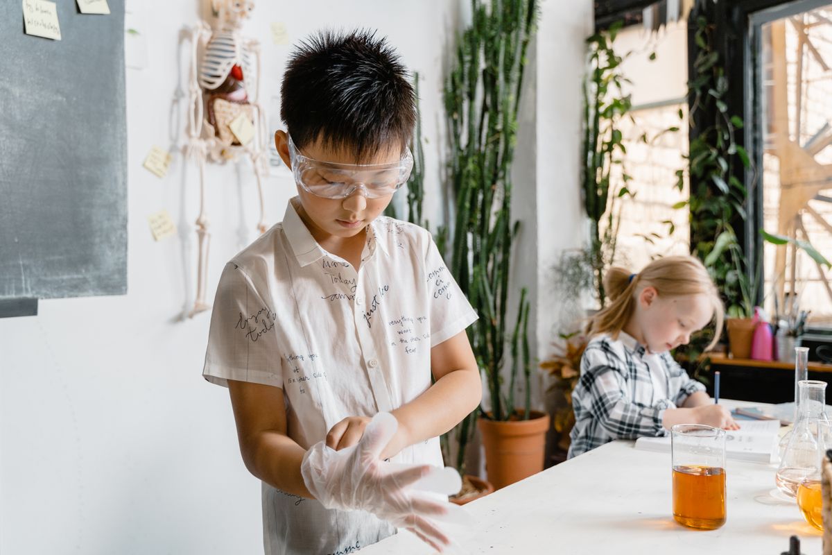 Students conducting a science experiment with laboratory glassware