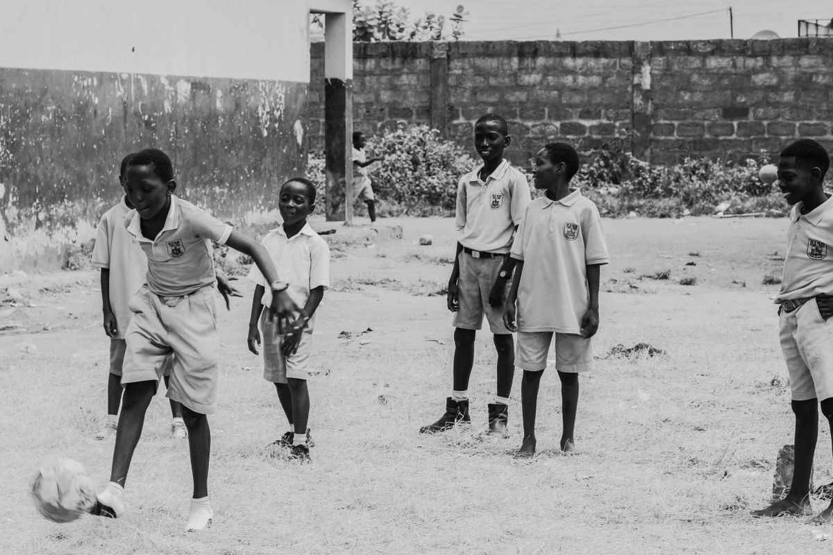 Children playing soccer on the school sports field