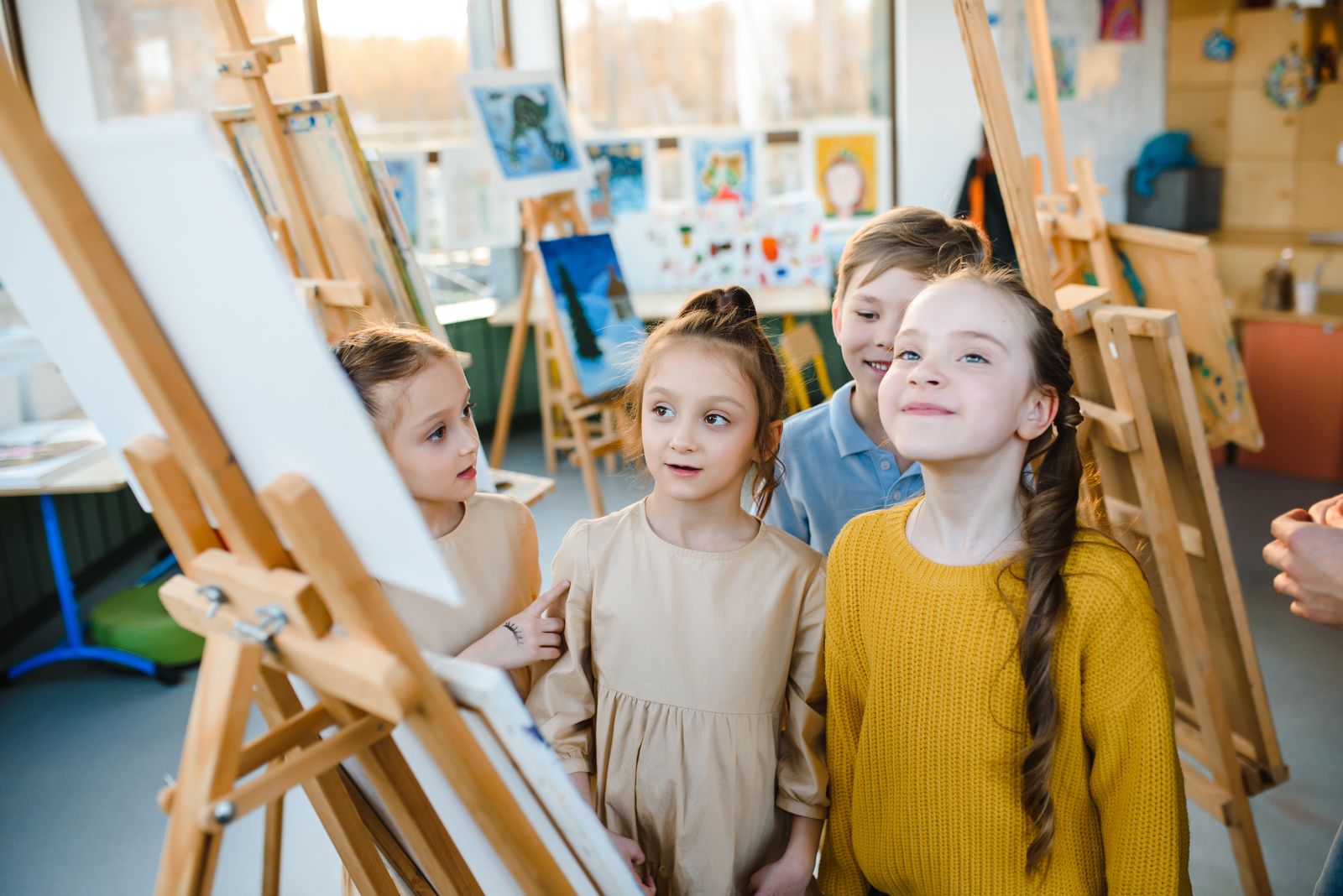 Young students painting at an art table