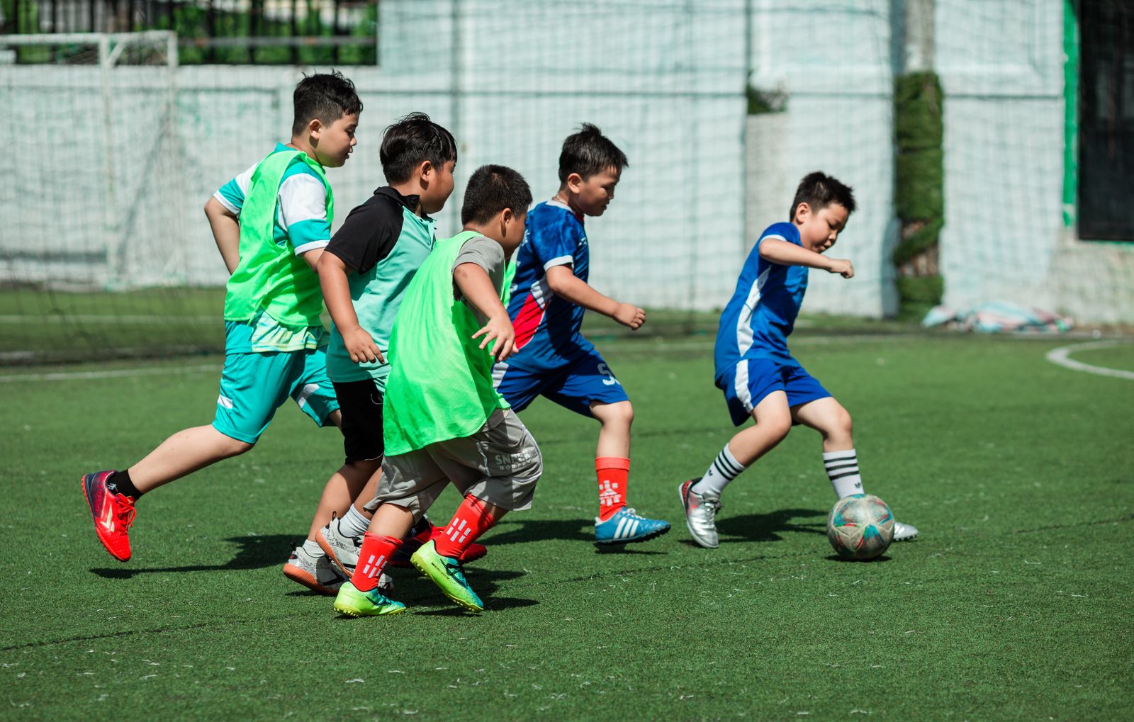 Children running together on the school sports field