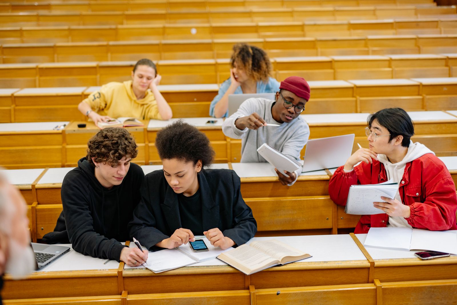 Three students reading and working together at a desk
